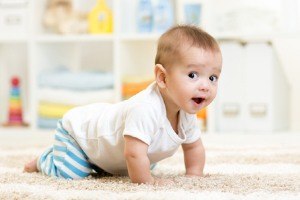 Baby crawling on white carpet