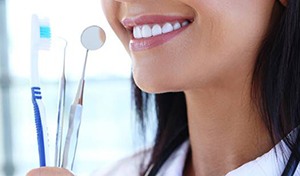 Close-up of healthy smile and dental tools